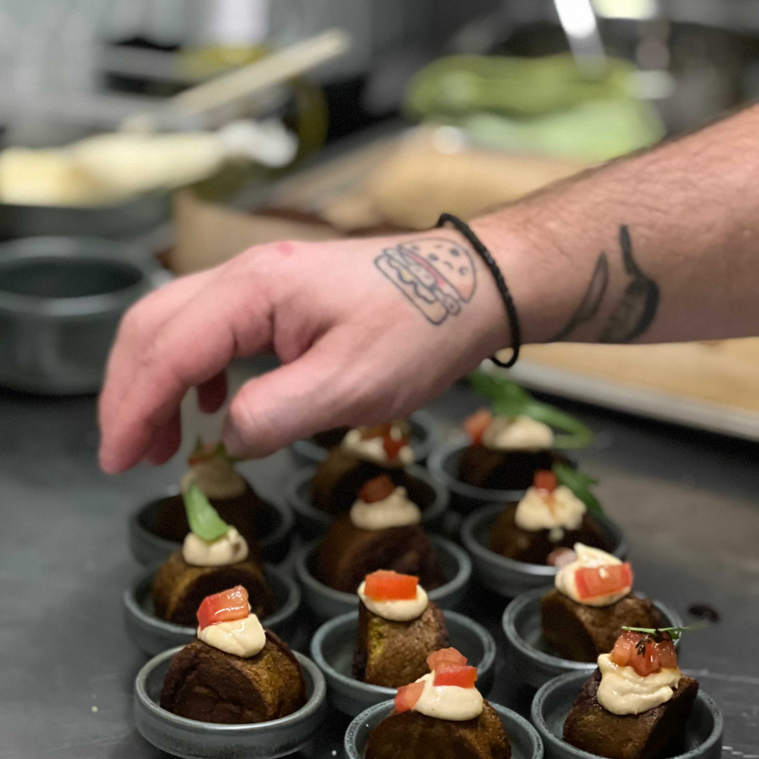 A picture of our chef preparing food for an event